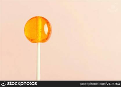 Single lollipop on pink pastel background with copy space
