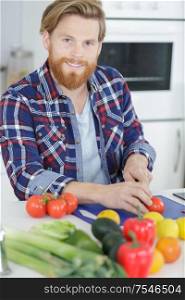 single man preparing vegetables at home