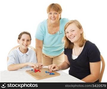Single mom and her two children playing a board game together.
