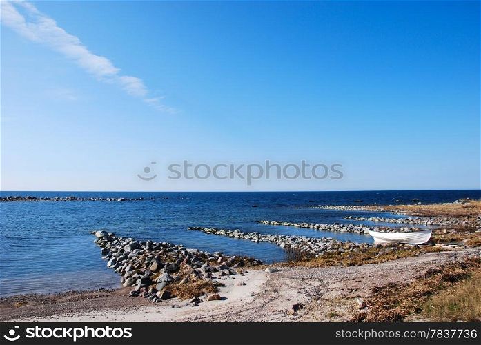 Single moored rowing boat at a rocky coast. From the swedish island Oland in Sweden.