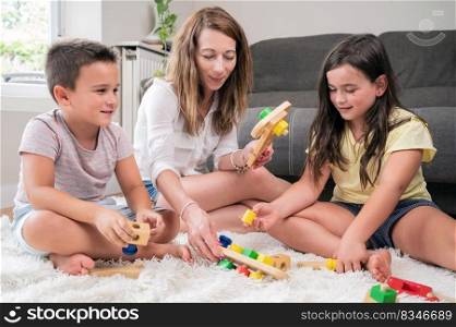 Single mother playing with her kids at home. High quality photography.. Single mother playing with her kids at home.