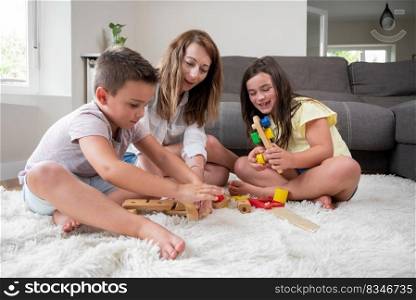 Single mother playing with her kids at home. High quality photography.. Single mother playing with her kids at home.