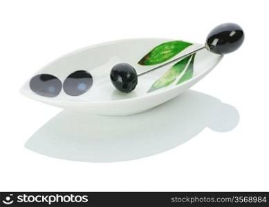 single olive on a plate with skewer