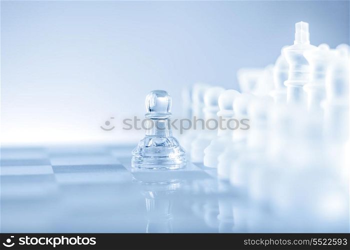 Single pawn staying against a full set of chess pieces.
