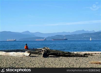 Single person looking out on to the water, Vancouver Canada.
