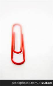 Single red paperclip