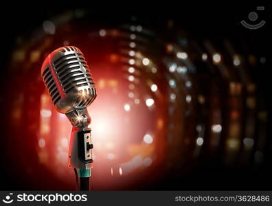 Single retro microphone against colourful background with lights