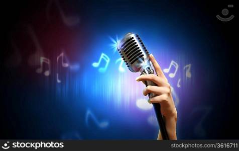 Single retro microphone against dark background with music notes