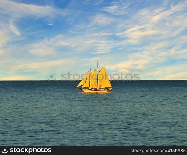 Single sail boat on the lake at sunset