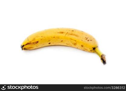 single un-peeled yellow banana isolated on white background