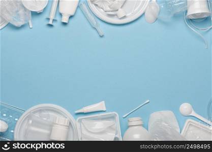 Single-use plastics. Plastic waste, ecological pollution. Frame banner background of white packaging plastic products. Top view flat lay.