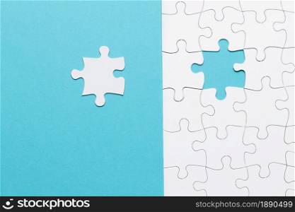 single white jigsaw puzzle piece blue background . Resolution and high quality beautiful photo. single white jigsaw puzzle piece blue background . High quality and resolution beautiful photo concept