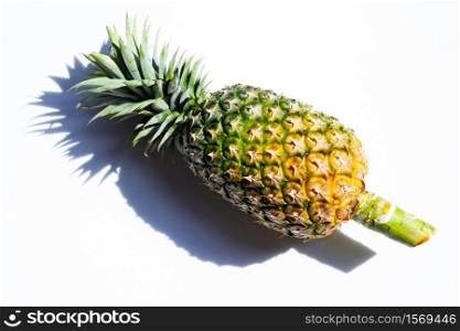 Single whole pineapple on white background.