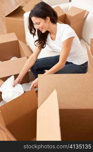 Single Woman Unpacking Boxes Moving House