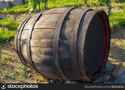 single wooden cask with wine laying on the ground