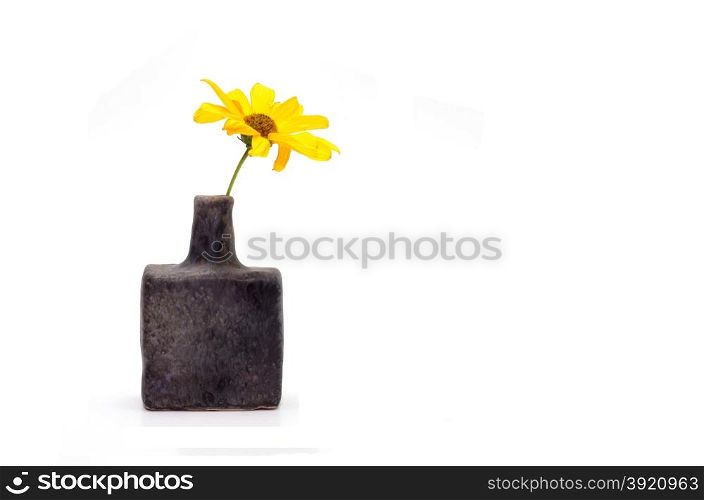 single yellow flower in old vase isolated over white