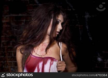 Sinister woman in a bloody shirt