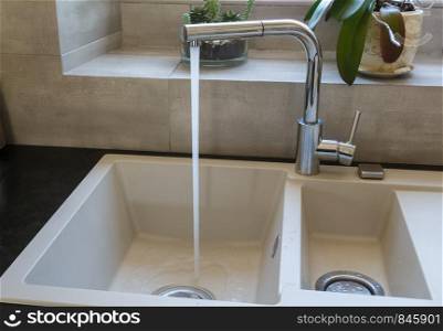 Sink of a kitchen with water flowing