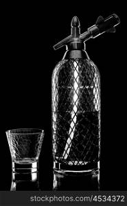 siphon with soda copulation on the table on a black background with an empty Cup
