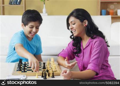 Sister and brother playing chess in living room