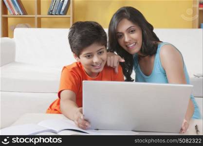 Sister and brother working on laptop