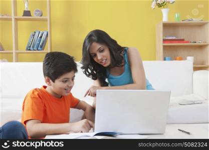 Sister and brother working on laptop