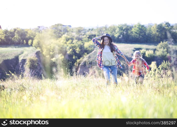 Sister girls having fun in the meadow