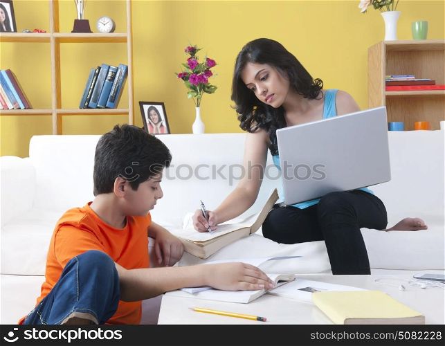 Sister helping her brother with homework