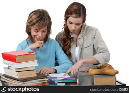 Sister helping her sibling with an assignment