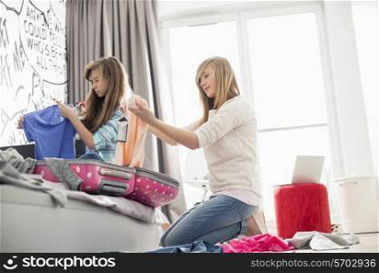 Sisters cleaning bedroom