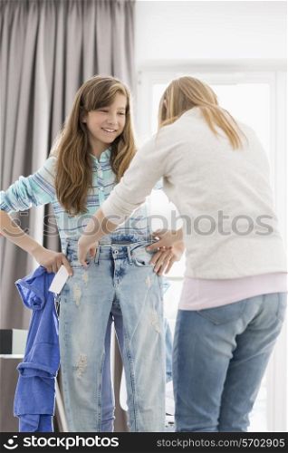 Sisters trying on clothes at home