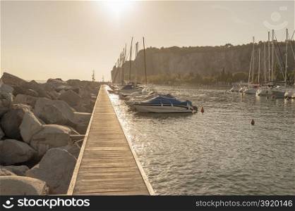 Sistiana, Trieste, Italy - July 28, 2015: Pleasure Boats moored in the harbor at sunset