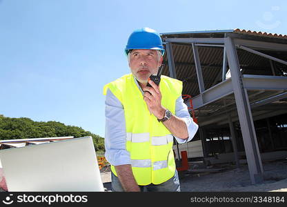 Site manager using walkie-talkie