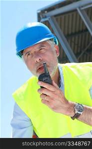 Site manager using walkie-talkie