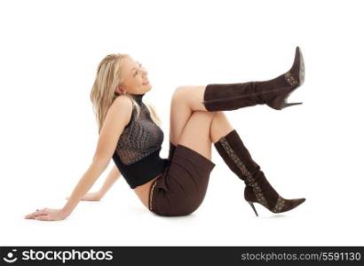 sitting blond in brown shorts and boots over white