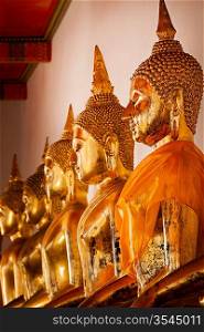Sitting Buddha statues close up. Wat Pho temple, Bangkok, Thailand