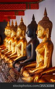 Sitting Buddha statues in Buddhist temple Wat Pho, Bangkok, Thailand