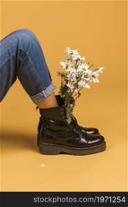 sitting female legs boots with flowers inside. High resolution photo. sitting female legs boots with flowers inside. High quality photo