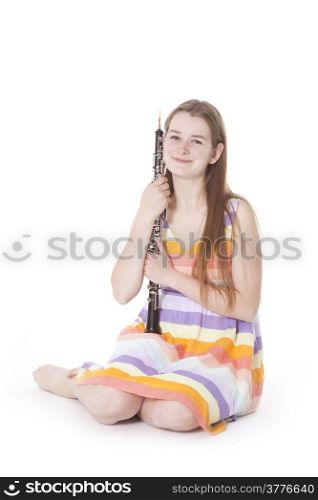 sitting girl in colorful dress with oboe against white background
