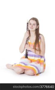 sitting girl in colorful dress with oboe against white background