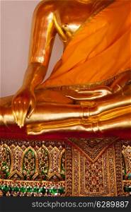 Sitting golden Buddha statue close up details. Wat Pho temple, Bangkok, Thailand