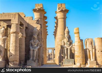 Sitting statues in Luxor Temple at sunny morning