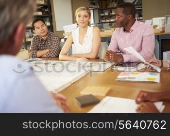 Six Architects Sitting Around Table Having Meeting
