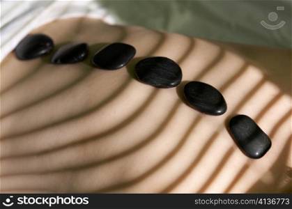 Six black stones for spa-massage on a back