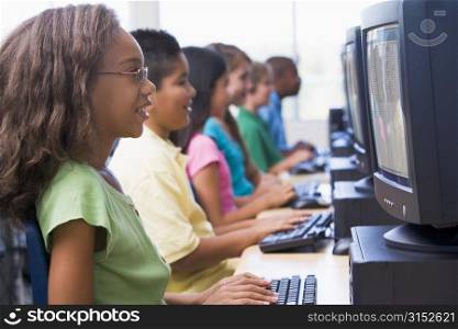 Six children at computer terminals (depth of field/high key)