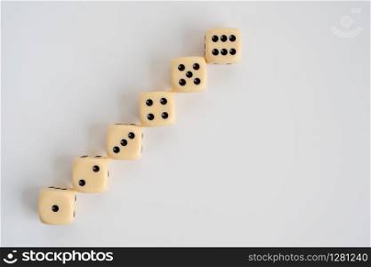 Six dice laid out in the form of a staircase, numbers from 1 to 6, steps to success