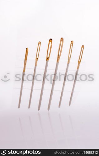 Six different sewing needles isolated on a white background