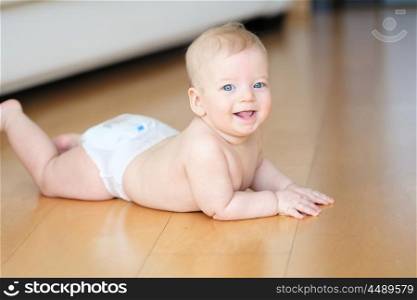 Six months old baby crawling on floor