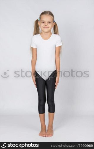 six year old girl aspiring gymnast performs a number of training exercises. Six year old girl preparing to take the test