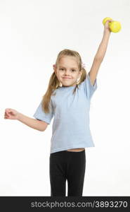 Six year old girl Europeans engaged in physical exercises. Six year old girl held up a dumbbell